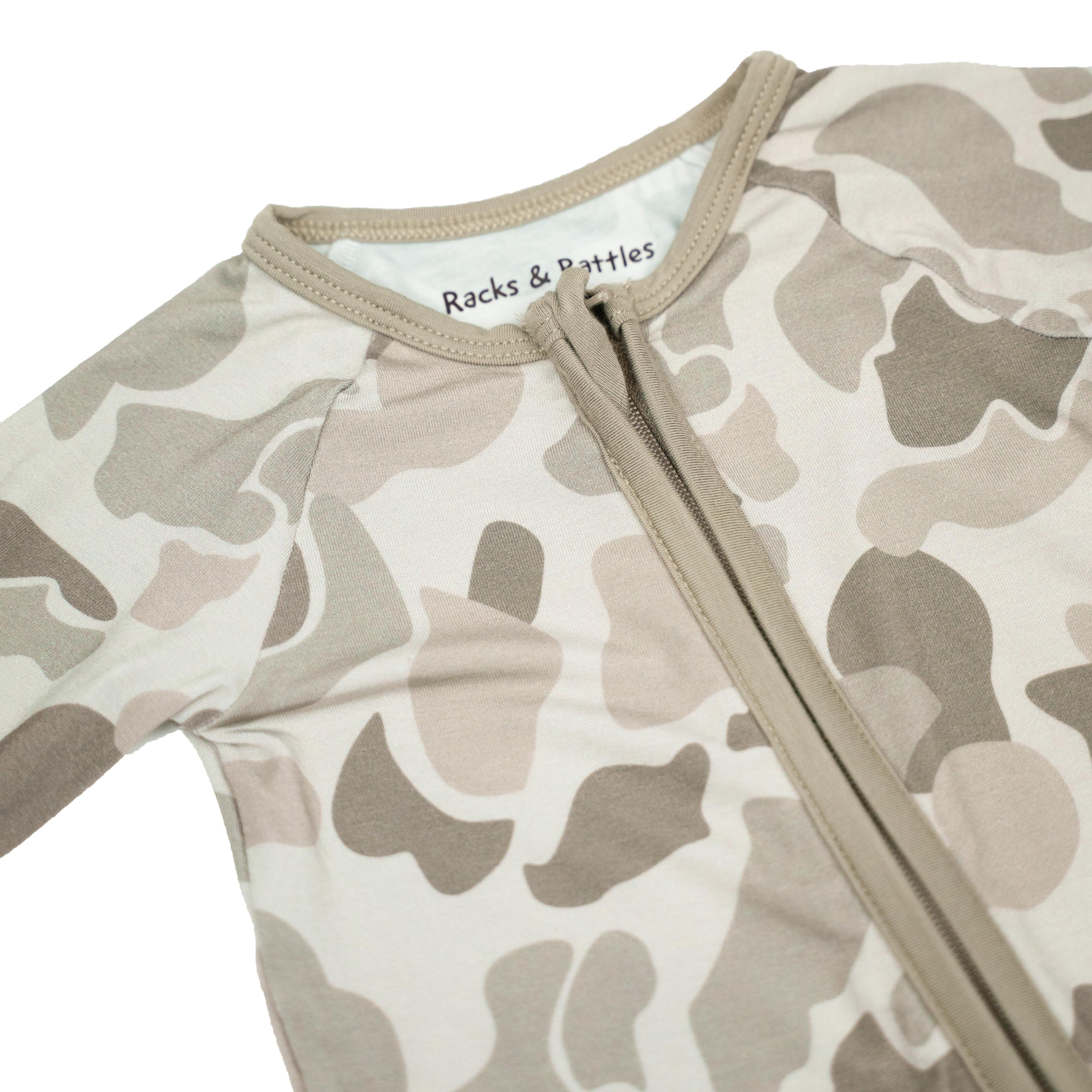 Button Buck Camo Baby Zippy in soft bamboo fabric with camouflage pattern and zipper design for easy dressing.