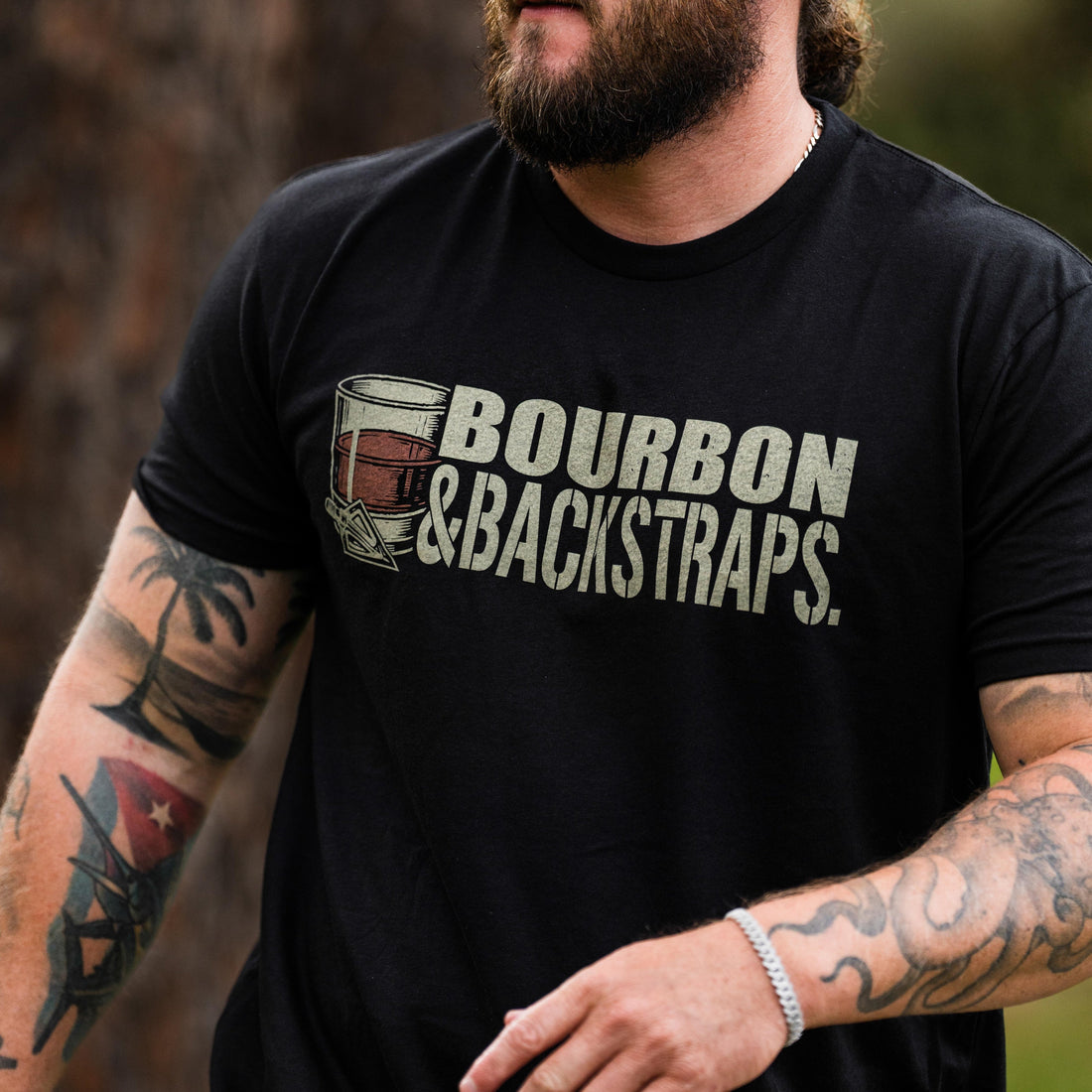 Bourbon &amp; Backstraps Tee featuring a bold graphic design on a black premium t-shirt for outdoor style.