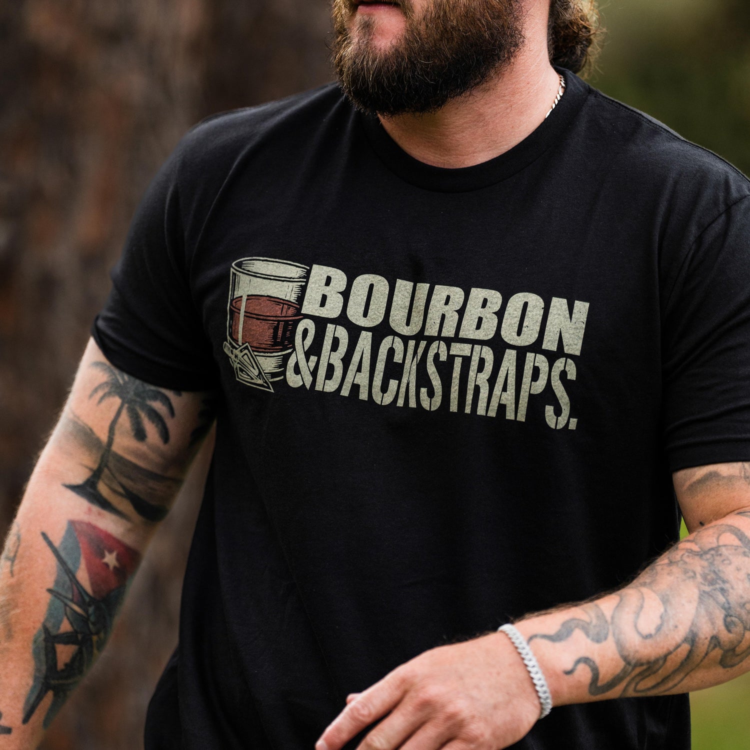 Bourbon & Backstraps Tee featuring a bold graphic design on a black premium t-shirt for outdoor style.