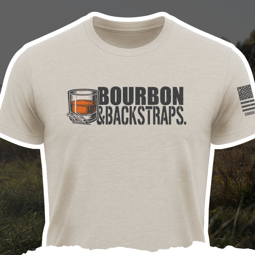 Bourbon &amp; Backstraps Tee Sand featuring a whiskey glass design on a soft, breathable t-shirt, perfect for hunters.